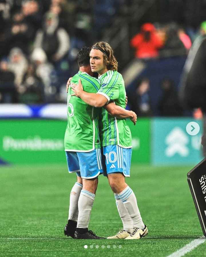 Image - Alex Roldan hugging one of his teammates, Pedro, on the pitch. 