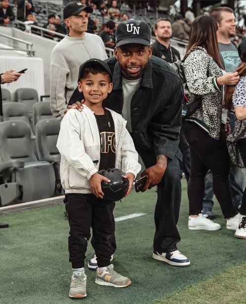 Image - Kellyn Acosta on the pitch with his son, Emerson Acosta. 