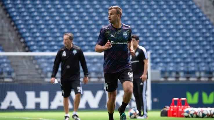 Image - Justin Dhillon with his teammates on the pitch. 