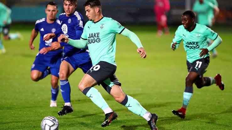 Image - Ruben Rodrigues on the pitch, playing for Notts County against two opponents. 